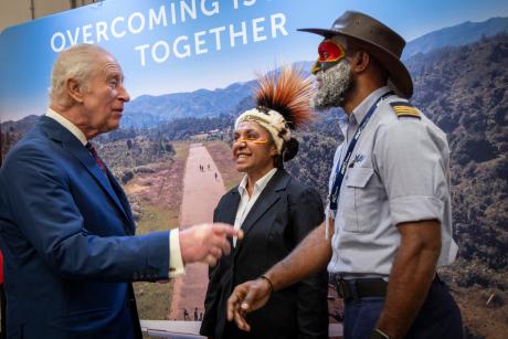 The King meets MAF pilot Joseph Tua & flight ops supervisor Serah Michael, both dressed in PNG atire