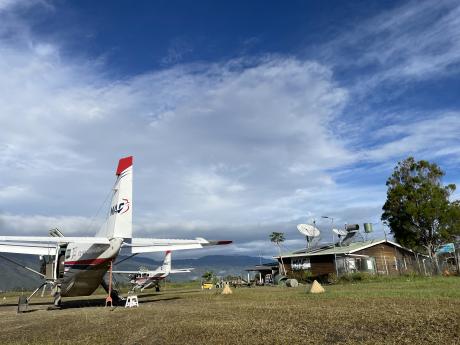 2 aircraft parked at Telefomin base in the morning sun