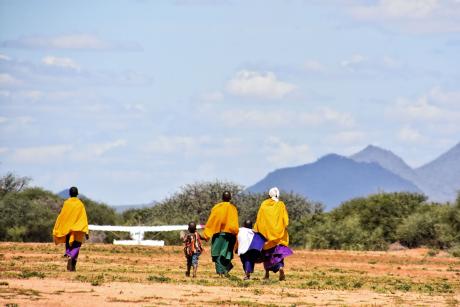 Locals walking towards the plane