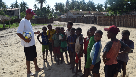 Njaka coaching children before football game