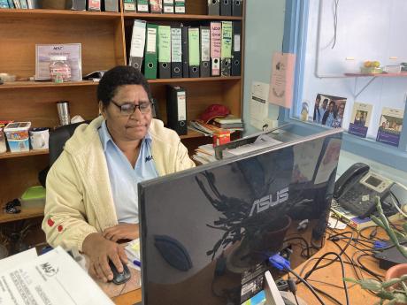 Janet Hat working at her desk