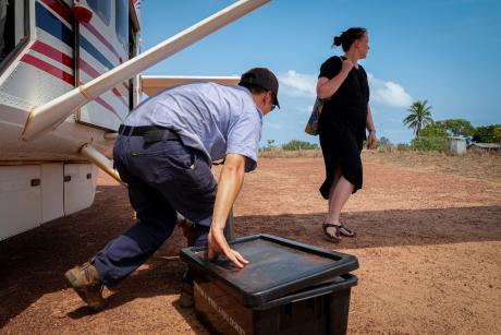 MAF pilot unloads school supplies from plane.