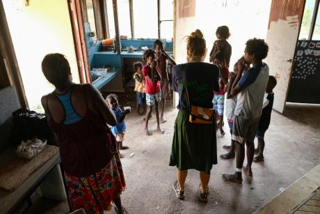 Teacher and students completing warm-up activity before class. 