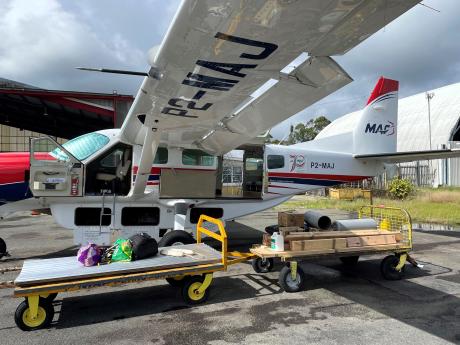 building materials spread across 2 trolleys ready to be loaded on the MAF plane
