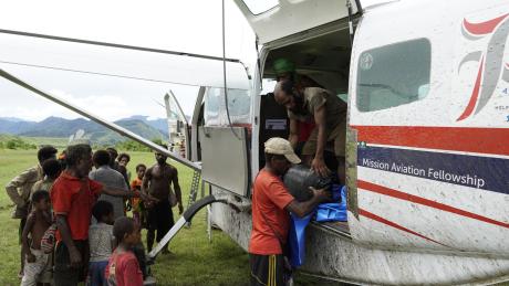 Mamusi locals unloading cement bags from MAF flight.