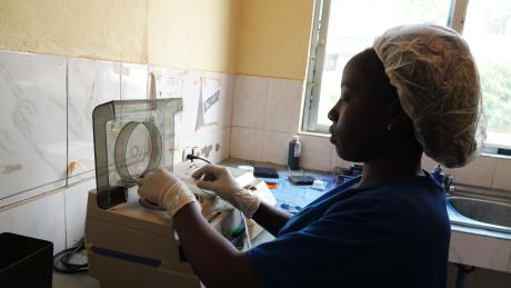  Seny Ninahara examining blood samples at the Hope Clinic laboratory.