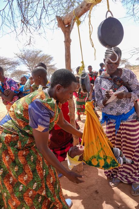 Infant weight monitoring during a mobile clinic at Chidudu airstrip.