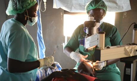 Dr Aja Paul operates in a tent at a Carter Center outreach in Yuai, Jonglei State, 