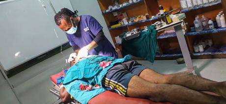 A health worker attends to John Boss at Kundiawa Hospital.