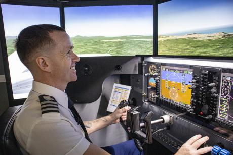 Student at flight simulator controls