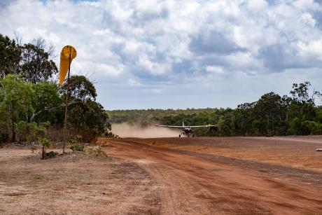 Cessan Caravan landing on dirt airstrip
