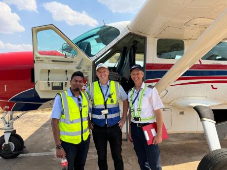 Pilots Roshan Stephen (L), Peter Griffin (C) and Andrew Parker (R) at Dodoma airport after the transitioning flight landed.