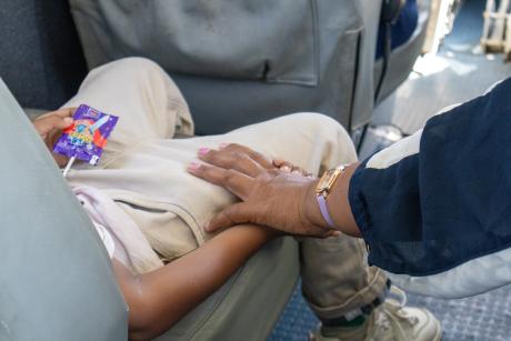 A boy's mother comforts him during flight in a small plane