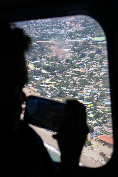 A passenger takes a photo on his phone from a plane