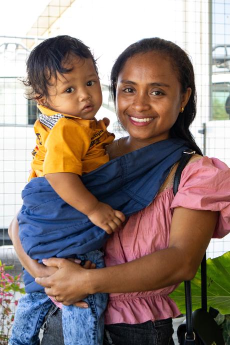 A woman holds a toddler 