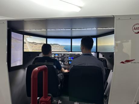 Student and instructor inside flight simulator