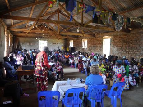 Richard Ocen (standing) during the women conference