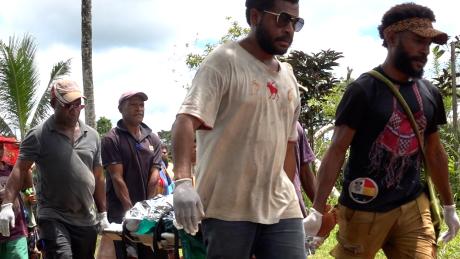 medevac patient carried to the aircraft aby the Mougulu clinic team