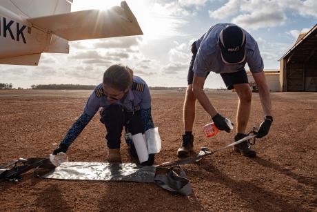 MAF pilots cleaning medical equipment after medevac flight