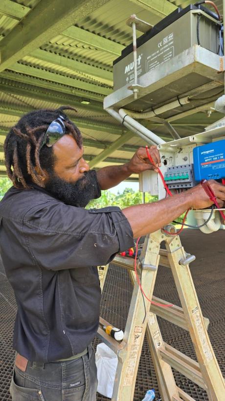  Brian Baimako working at solar equipment for ML school on his second visit