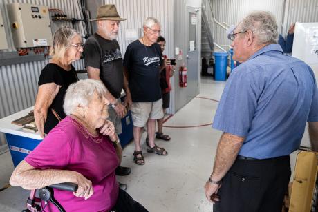 Small group of people on hangar and stores tour