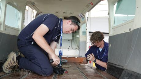 Matt Kaye and and Nathaniel Cunningham screwing in panels in the Caravan cabin