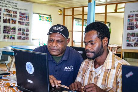 MAF’s BCT facilitator, Johnson Irarue, guiding a student with essential computer tips.