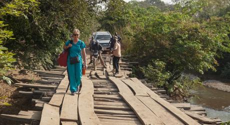 The medical team crosses the bridge that connects the village to the city