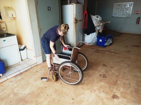 Reservations officer cleaning wheelchair