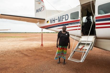 Yolngu woman standing outside plane