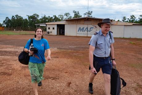 Teacher and MAF pilot heading out to aircraft on tarmac