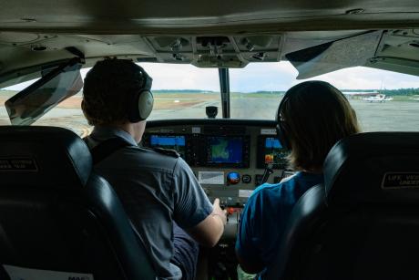 Pilot and teacher in plane