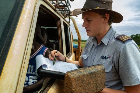 pilot greets students at muddy car