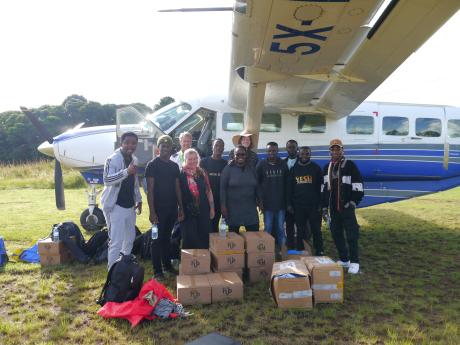 Pilot Andrew with the YWAM team at Bukasa Airstrip on L. Victoria 