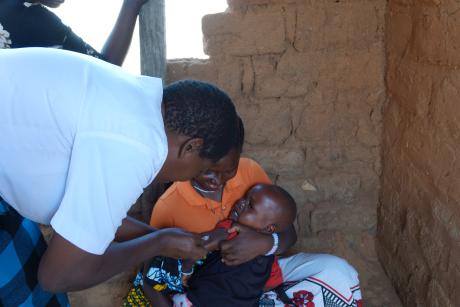 Emiliana vaccinating a child