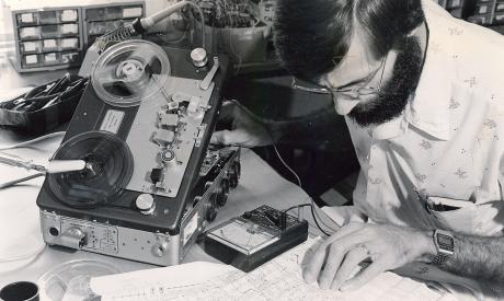A man fixing an electronic device
