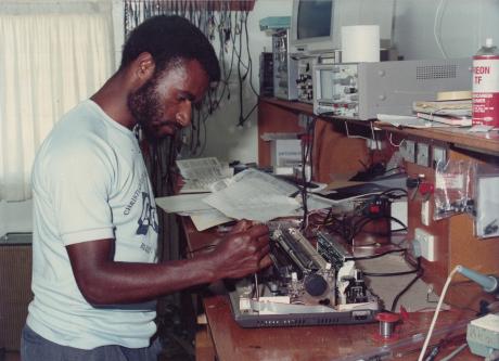 A man fixes a typewriter