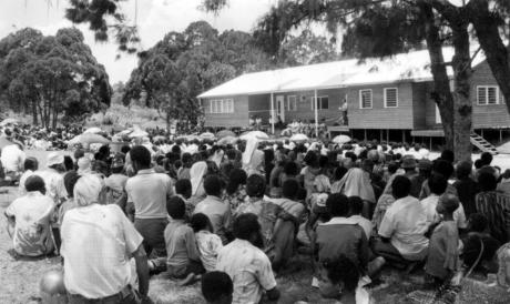 A crowd gathers outside a new building