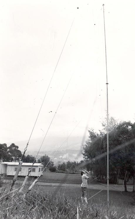 A man looks at a radio antenna
