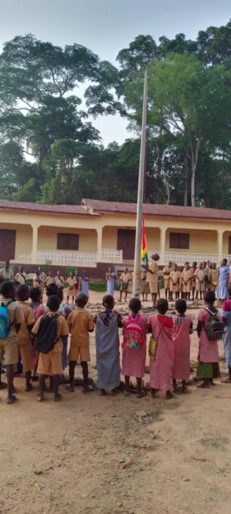 Students around the mast to raise the flag