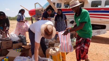MAF's pilot, Daniel Loewen helping to distribute food items.