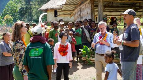 A group of people are welcomed in a village