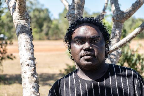 Student teacher standing in shade of tree