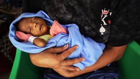 a baby in swaddling clothes