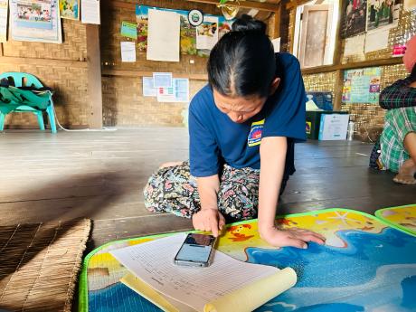 A woman uses a smartphone for healthcare work