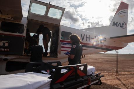 Paramedics with stretcher at aircraft