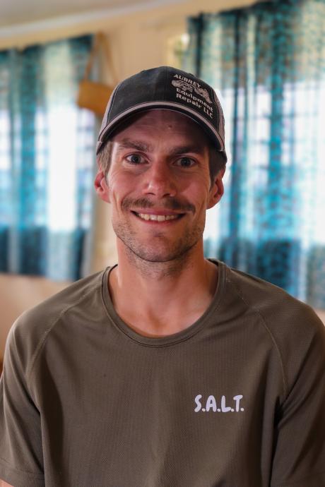 A man smiles at the camera