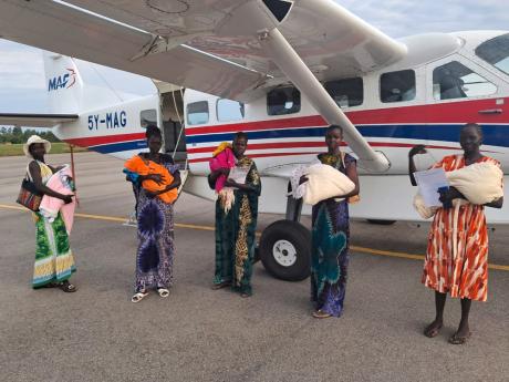 CURE patients and carers at Arua Airport 