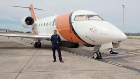 Pilot and aircraft on airport tarmac