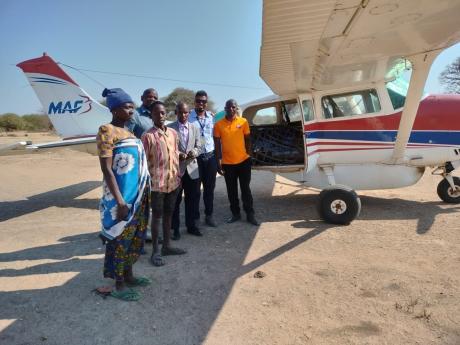 Pastor Obadia (orange t-shirt) after being received warmly in Mahaka